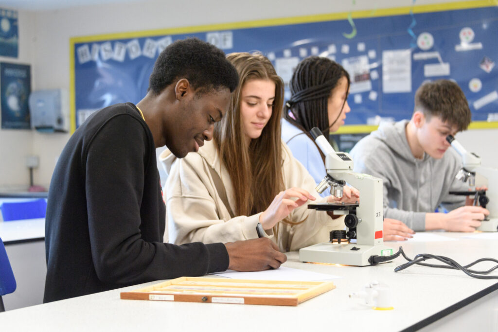 a picture of students using microscopes in a science lab