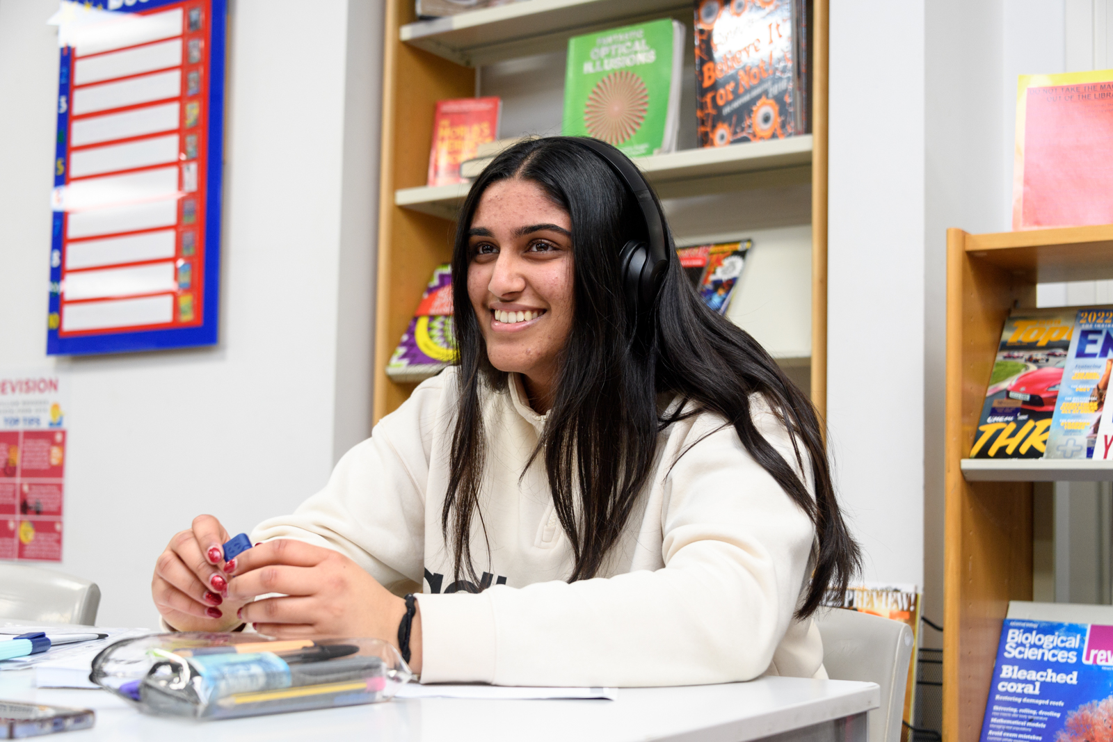 a student with headphones doing her work