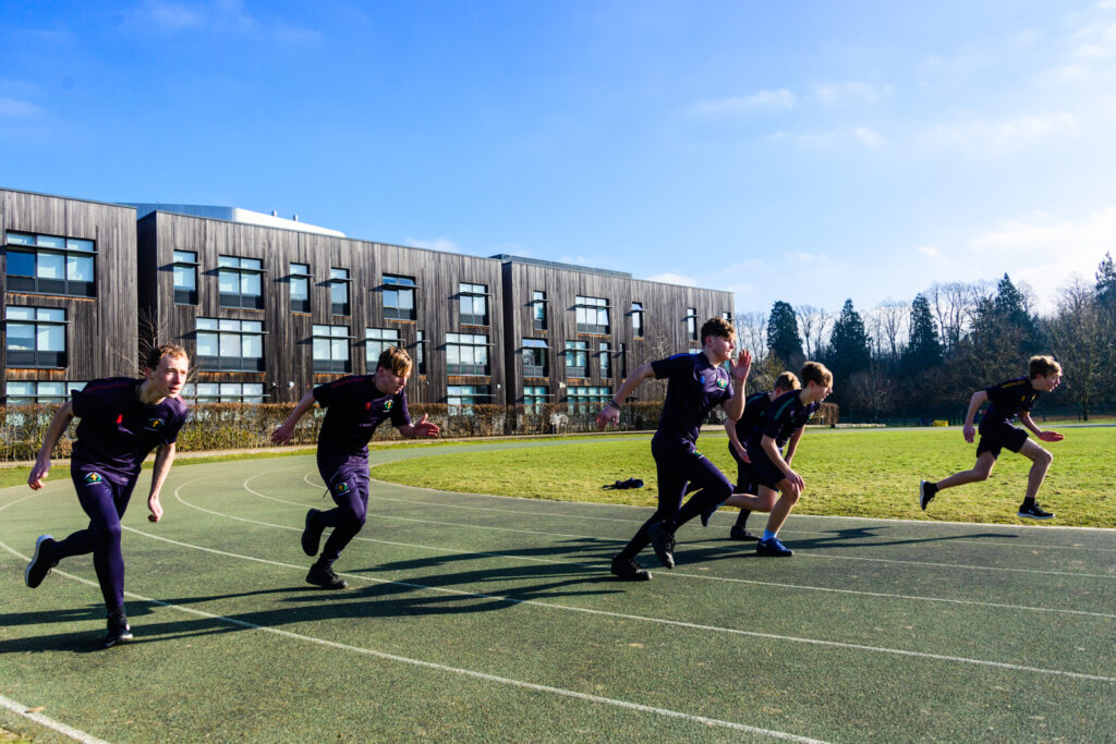 students running on the track and field