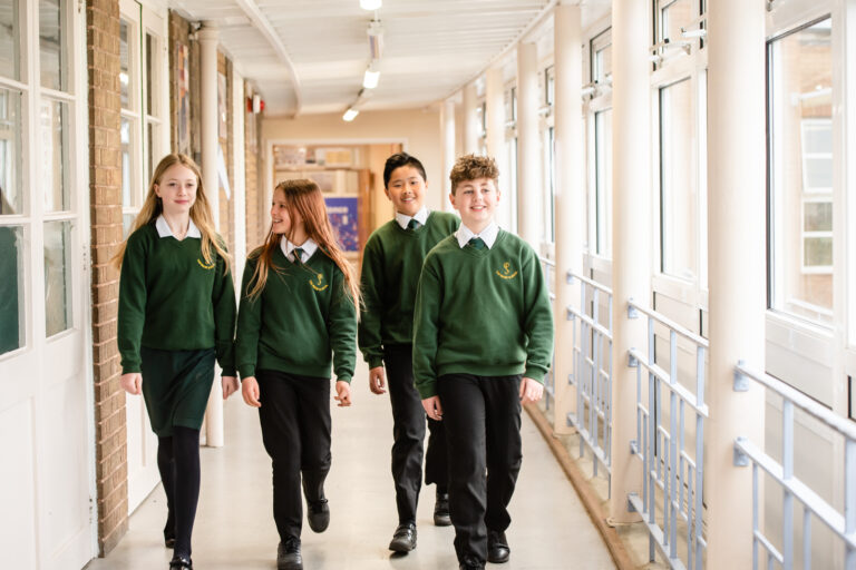 four students walking down a corridor